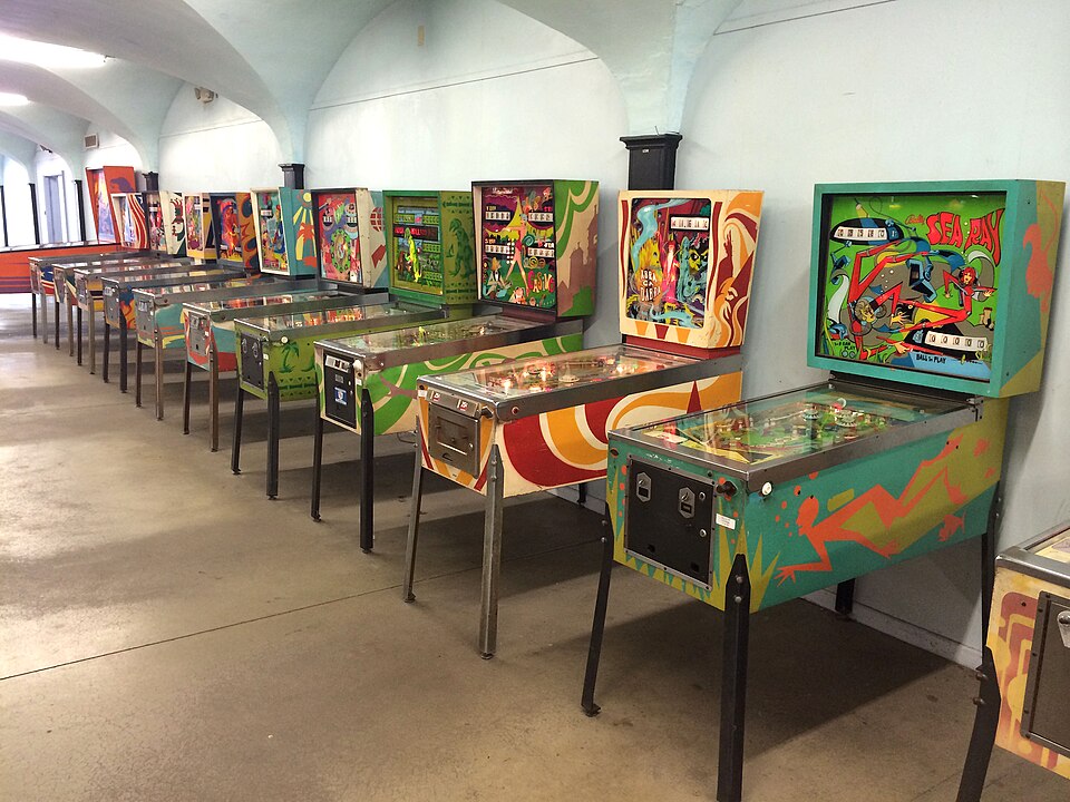 A row of modern pinball machines in an arcade